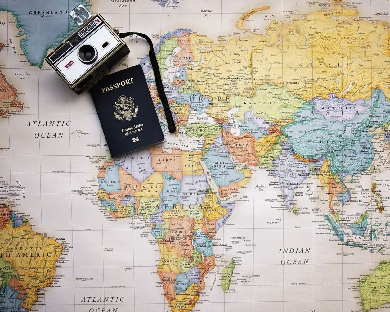Consultant handing a printed itinerary to a smiling couple